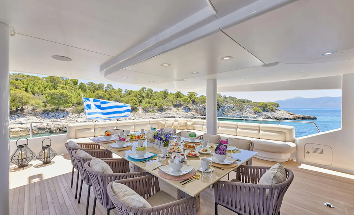 Daloli yacht dining area, outdoor seating with tables and chairs and scenic view