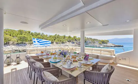 Daloli yacht dining area, outdoor seating with tables and chairs and scenic view