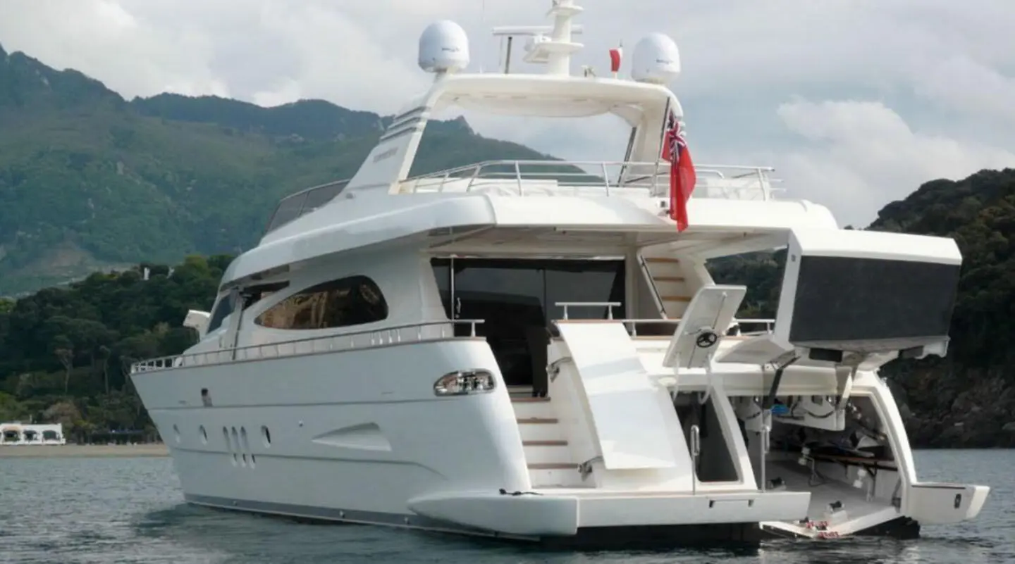 Miraval yacht anchored with a white hull and upper deck, lighthouse-like structure