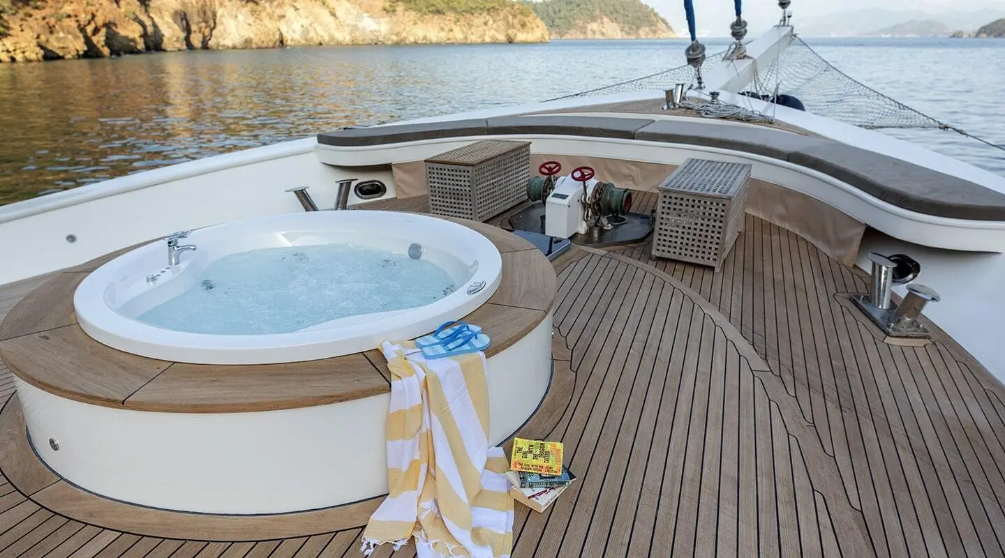 Kayhan Kaptan yacht deck at sunset with stairs, railing, and seating area