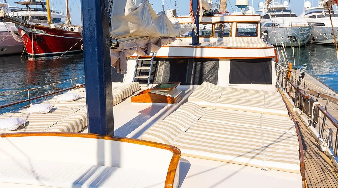 Gardelin yacht deck with wooden flooring and sun loungers at sunset