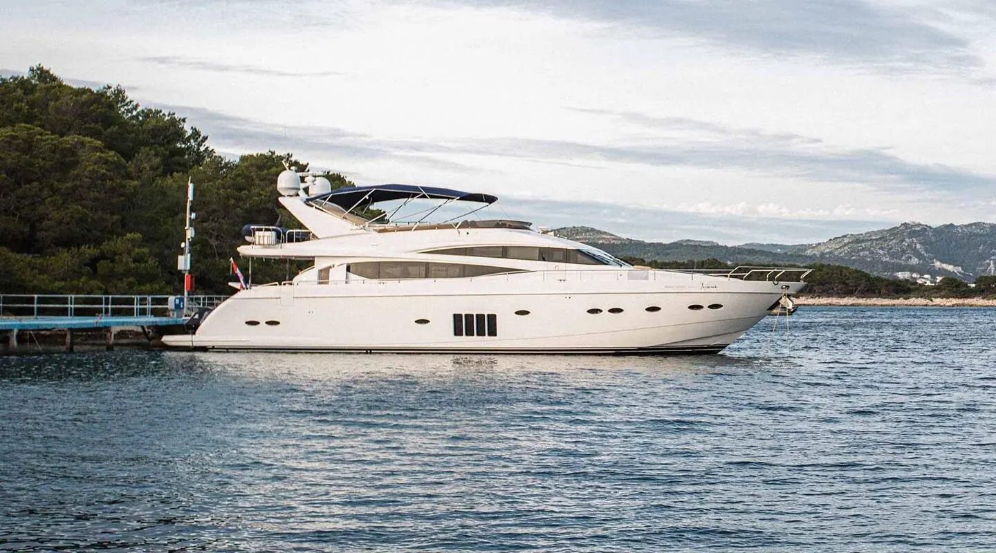 Insieme luxury motor yacht anchored on calm blue water with clear sky