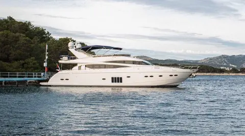 Insieme luxury motor yacht anchored on calm blue water with clear sky