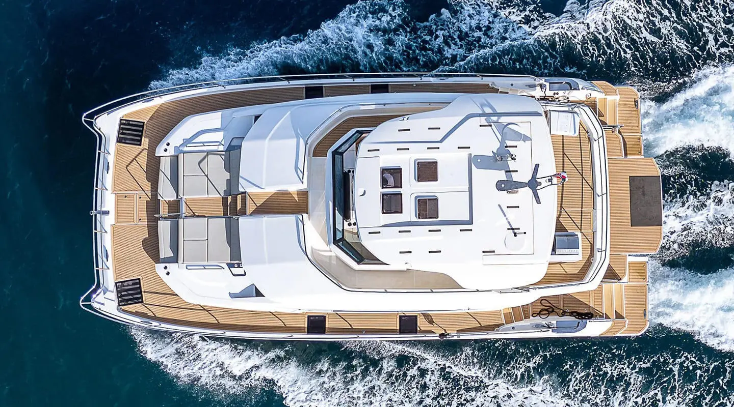 Top-down view of a luxury yacht named By My Side cruising, white deck and windows