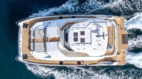 Top-down view of a luxury yacht named By My Side cruising, white deck and windows