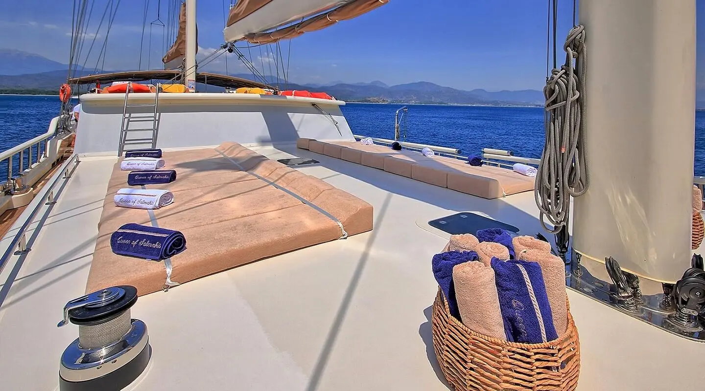 Sun deck on Queen Of Salmakis yacht with cushioned seating and view of sea