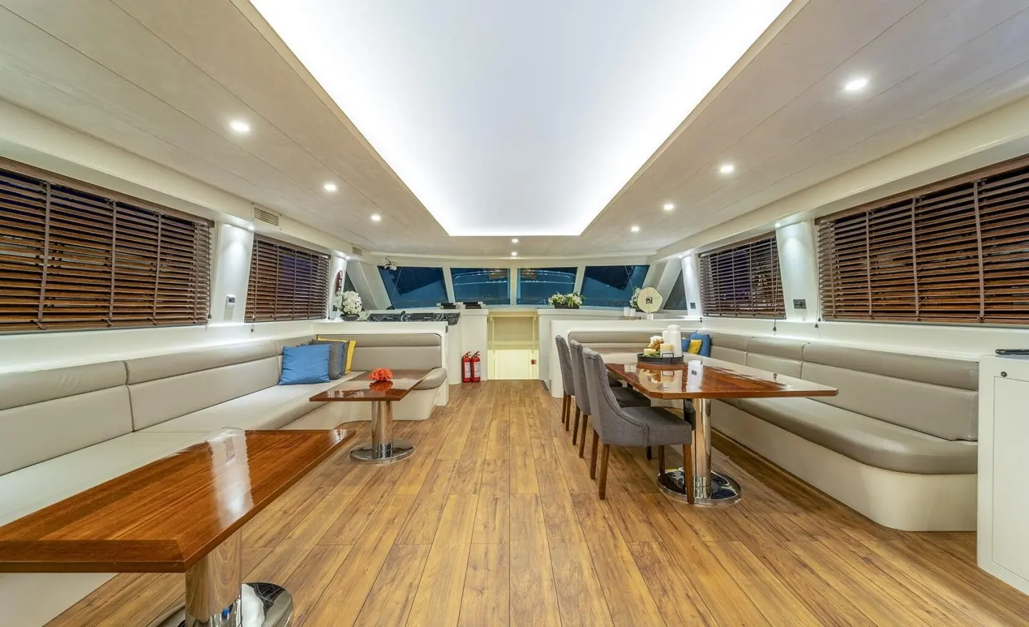 Interior of Queen Of Makri yacht: polished wood deck, seating, and helm area