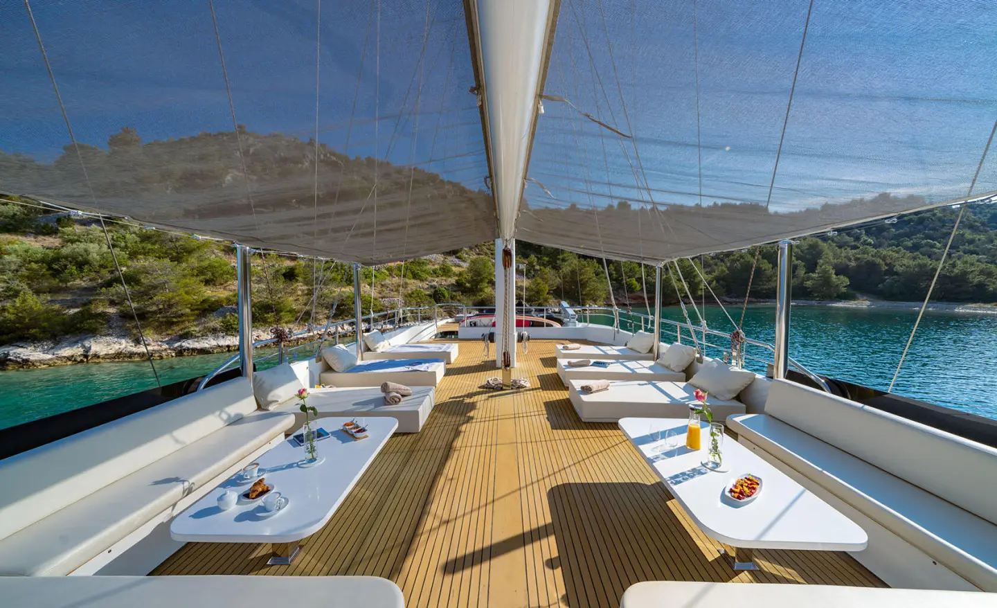 Navilux yacht sundeck with sun loungers and shaded seating area