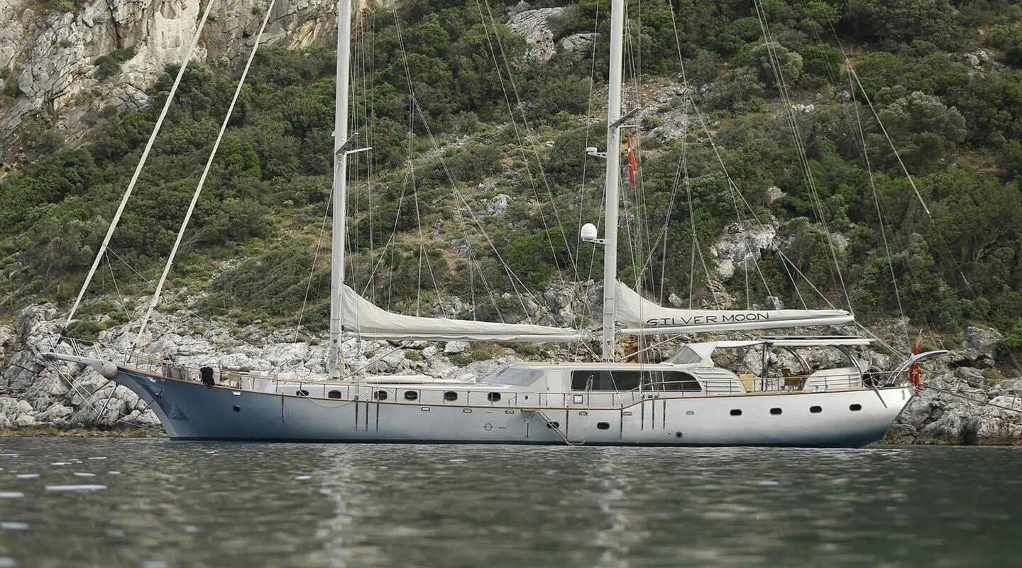 Silver Moon gulet seen from side with white sails and calm water