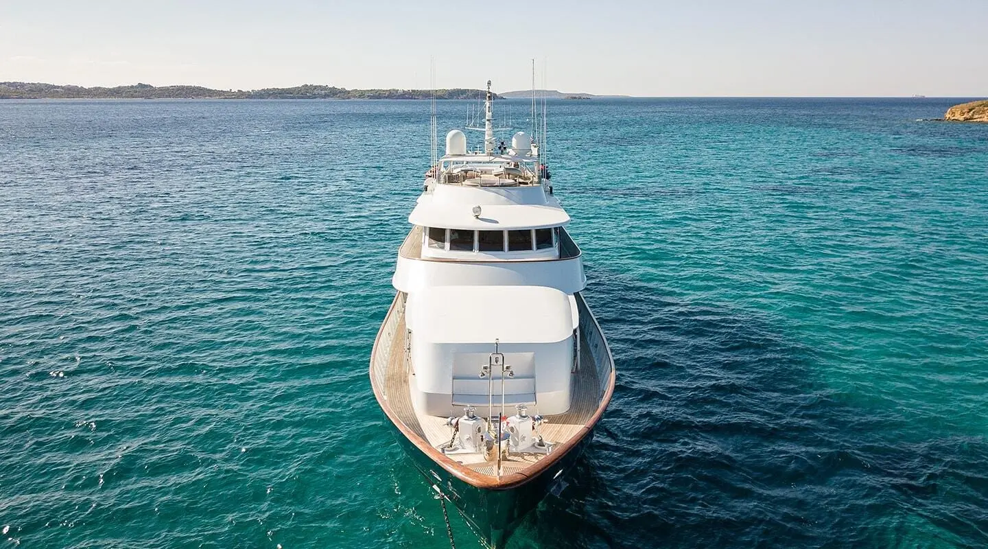 Top-down view of Wind Of Fortune yacht anchored in calm blue water, bow facing viewer