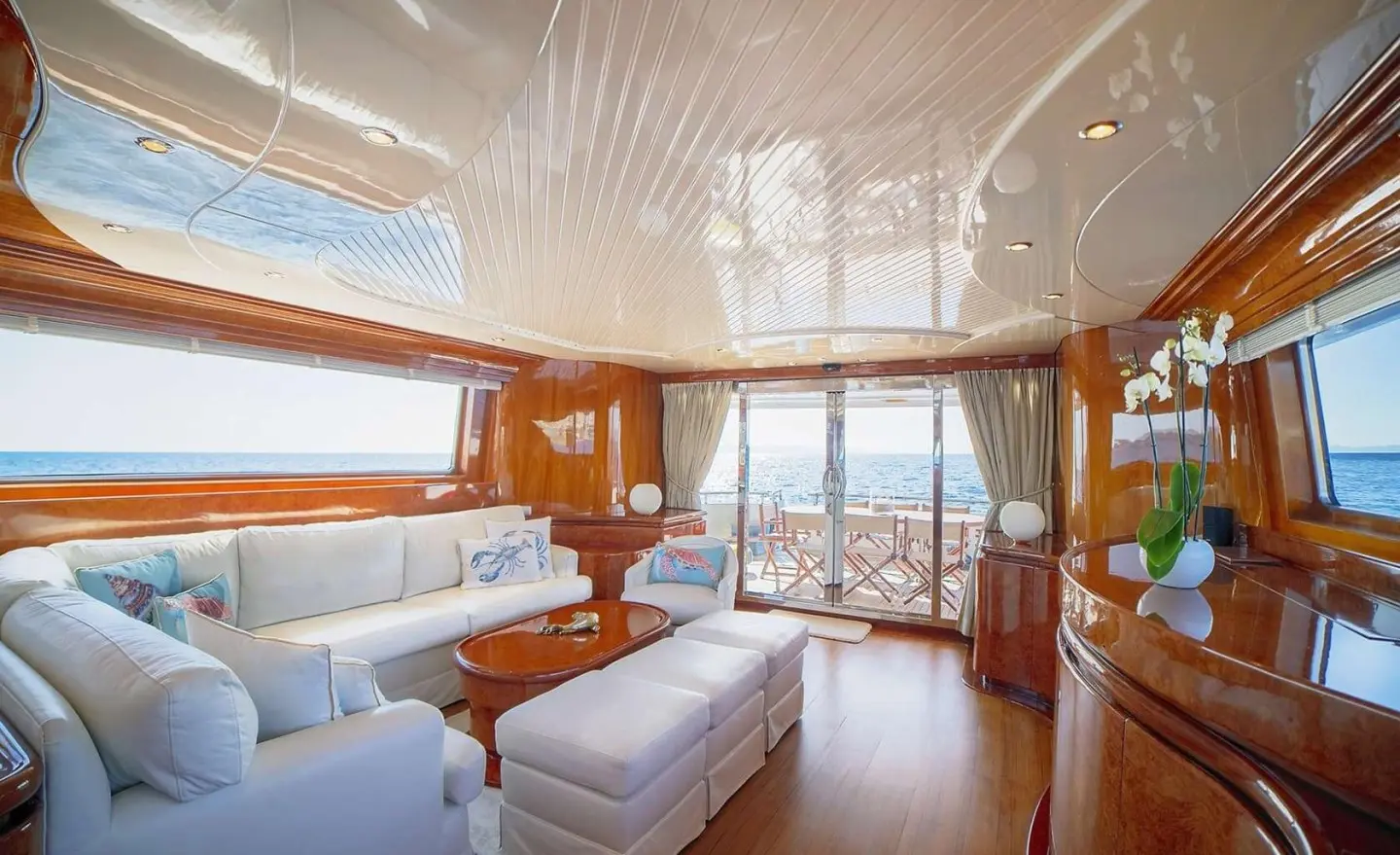 Zoi yacht saloon with wooden furniture and large windows