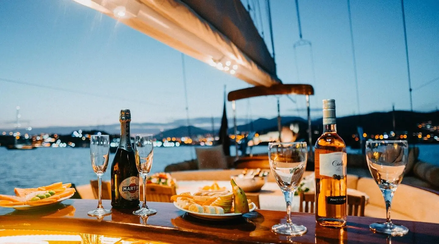 Wicked Felina yacht deck with table setting, drinks, and blue sea