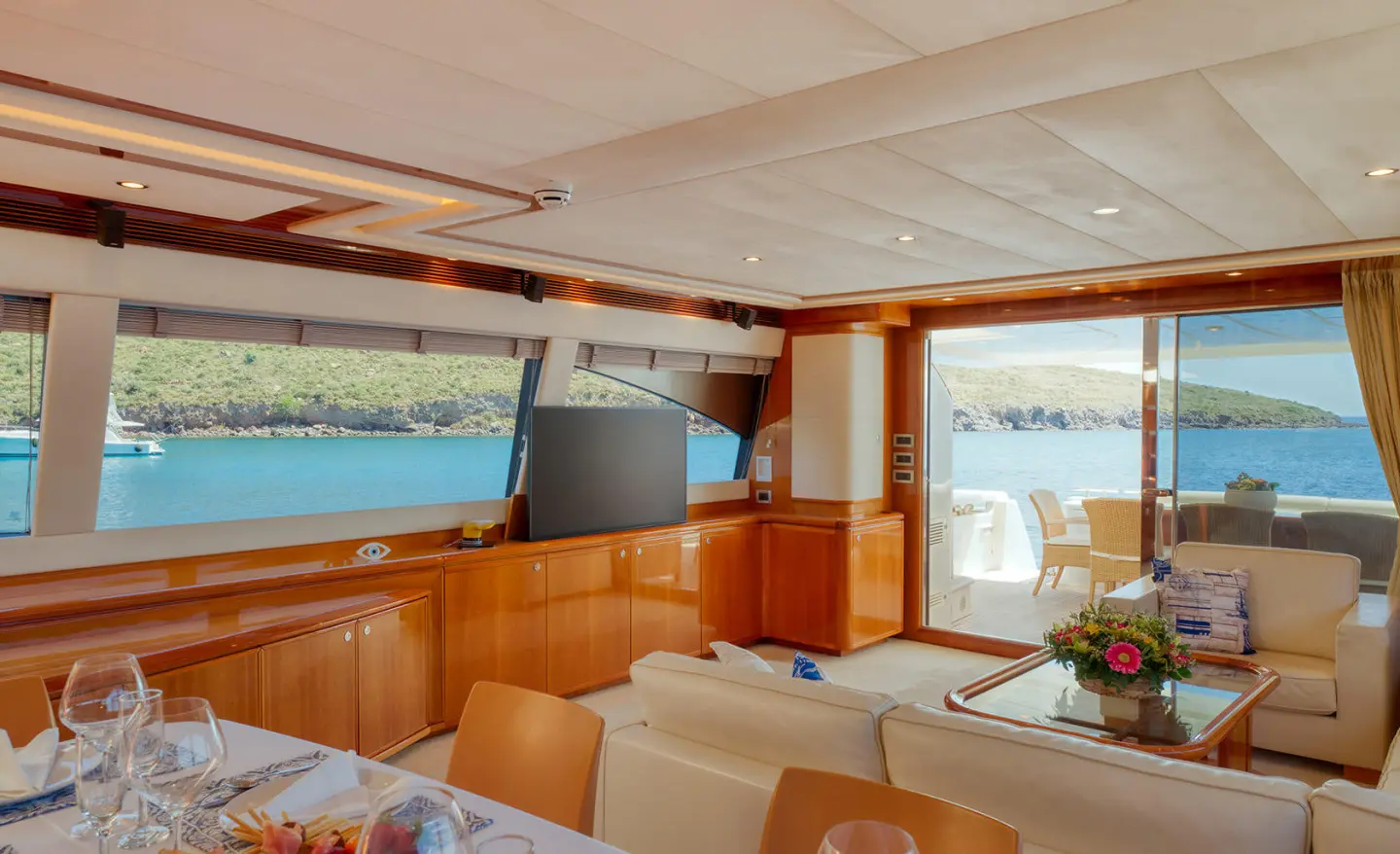 Interior of luxurious yacht Lidia saloon with seating and windows overlooking sea