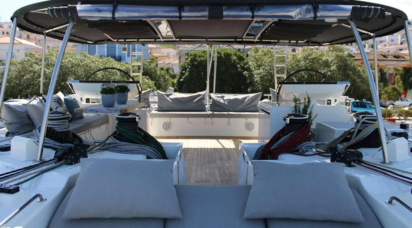 Yacht Atlantis flybridge lounge area with seating and sunshade, docked