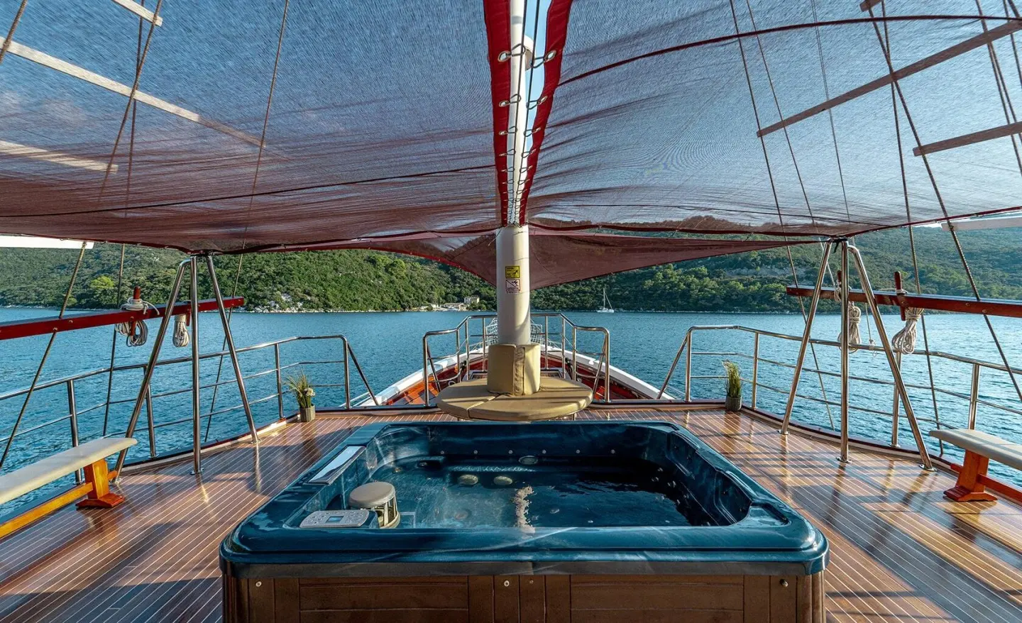 Cesarica luxury gulet at sunset with deck seating and rigging on calm water