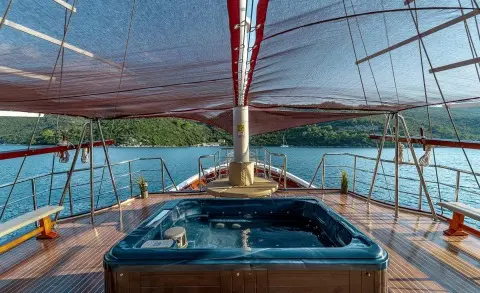 Cesarica luxury gulet at sunset with deck seating and rigging on calm water