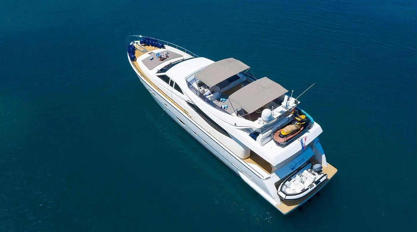 Quo Vadis I yacht anchored in clear blue water with sun deck and upper helm