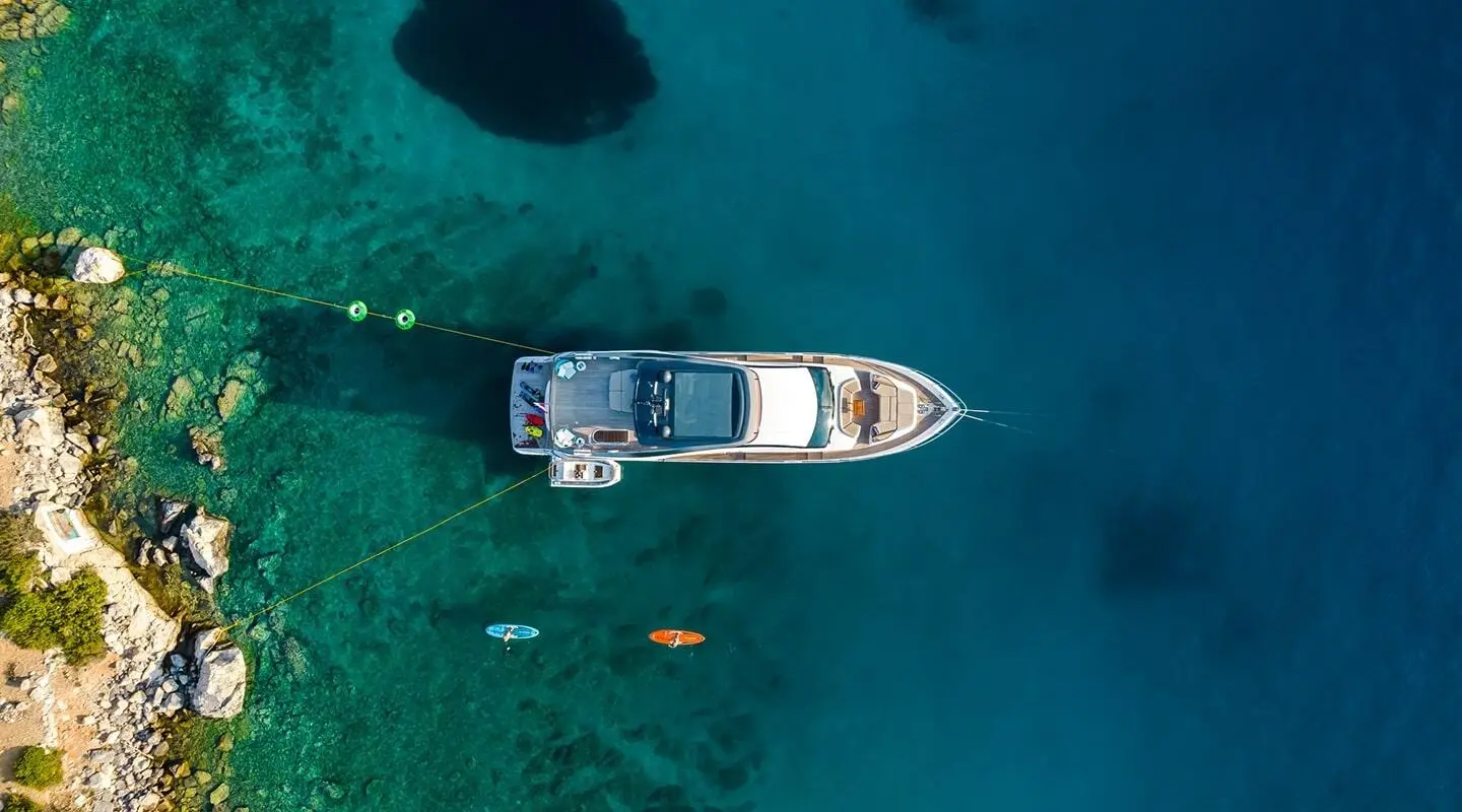 Aerial view of a yacht named Vista anchored in clear blue water
