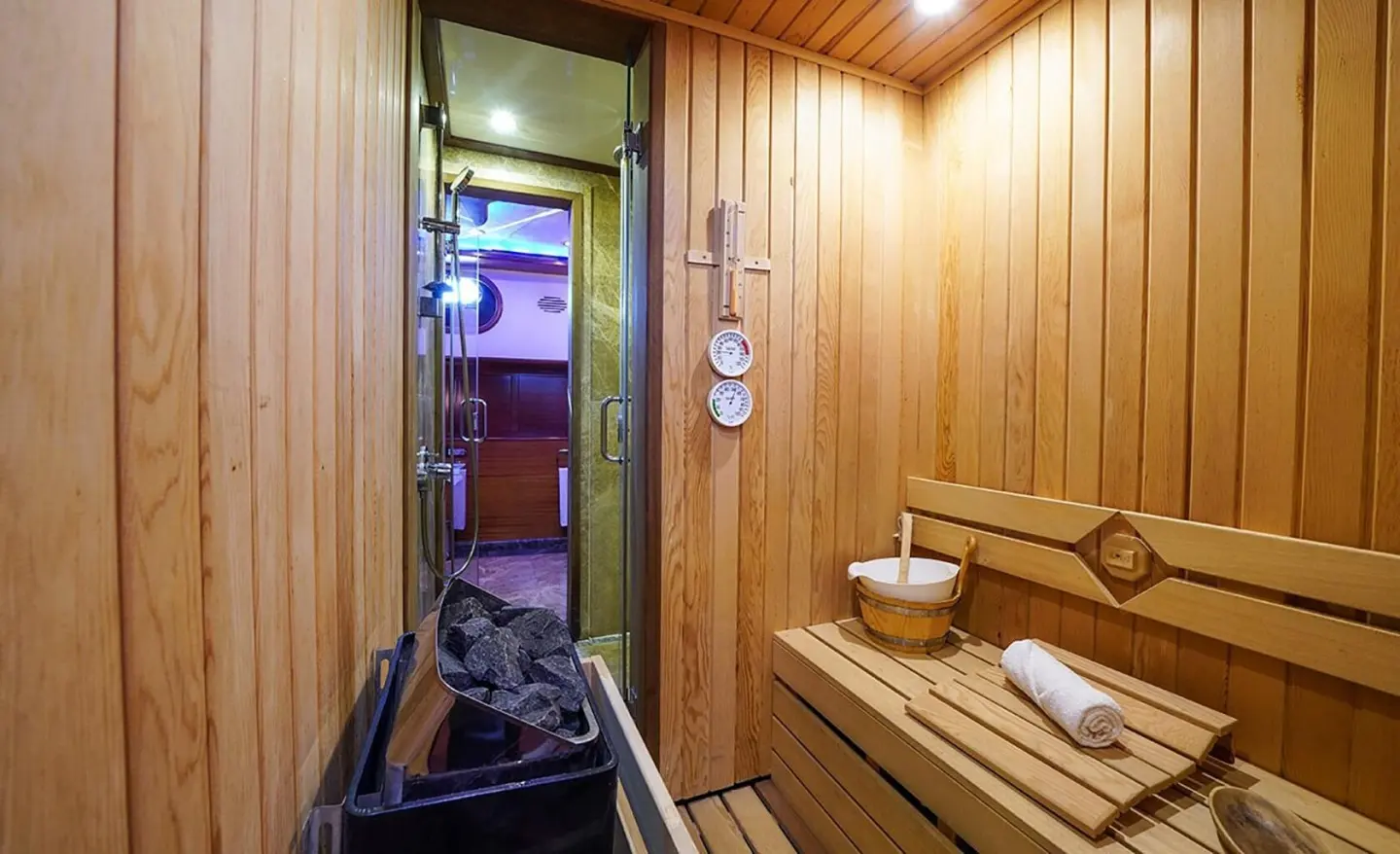 Interior view of a wooden sauna aboard La Bella Vita yacht at dusk