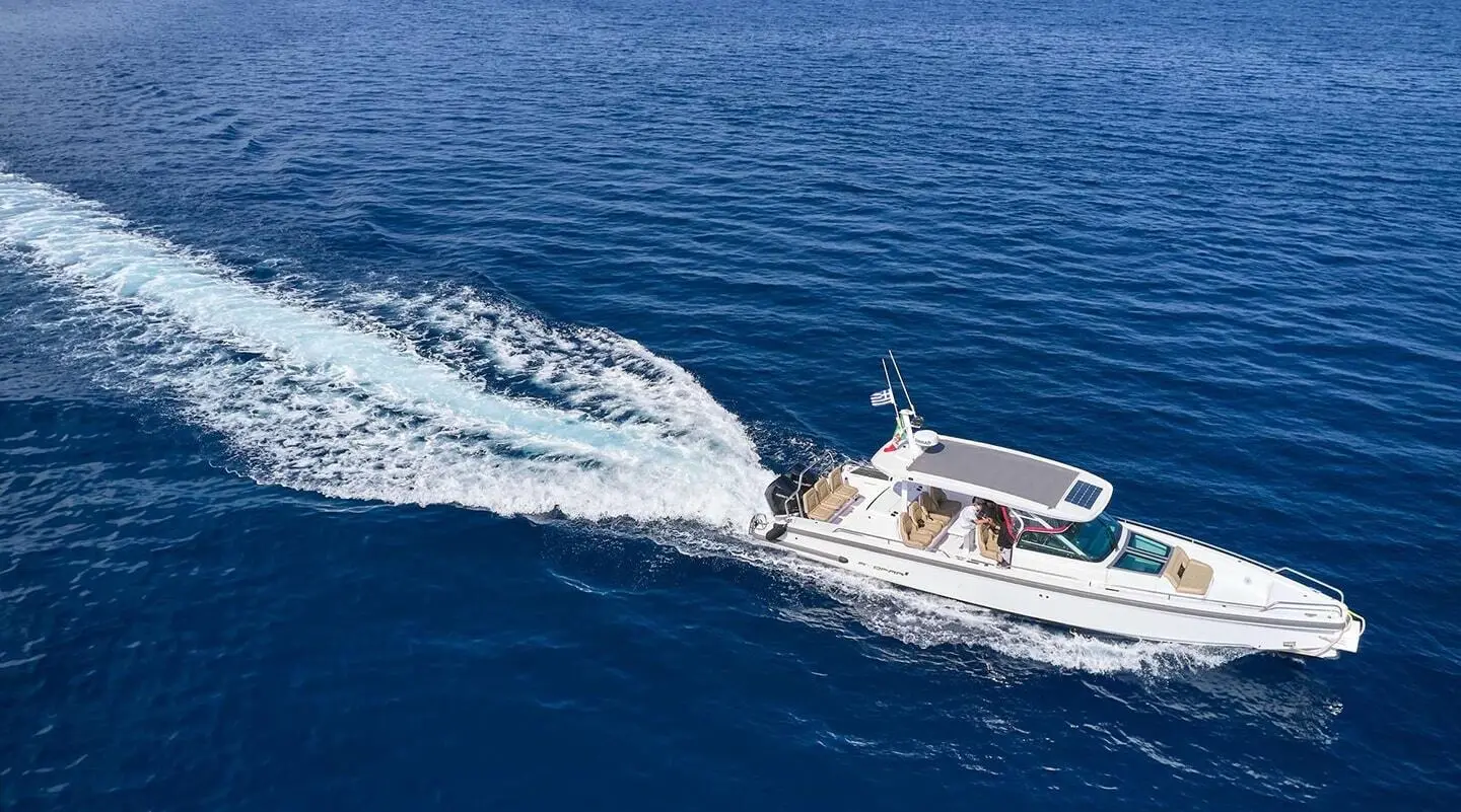 Genny luxury gulet sailing at sunset, white hull, deep blue sea, wake trail