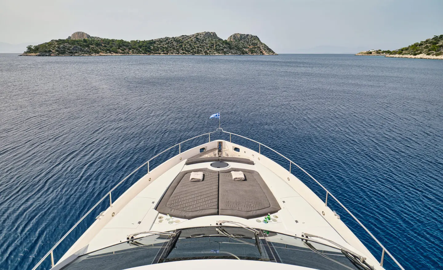 Bow view of M Five yacht sailing on calm sea, forward deck and rail
