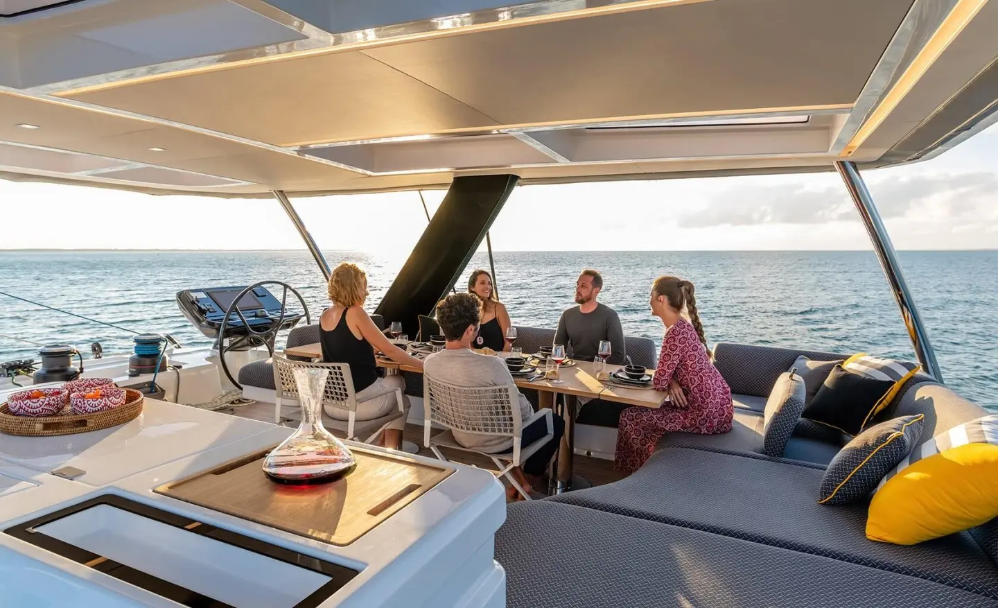 Daiquiri yacht group dining on aft cockpit with ocean view