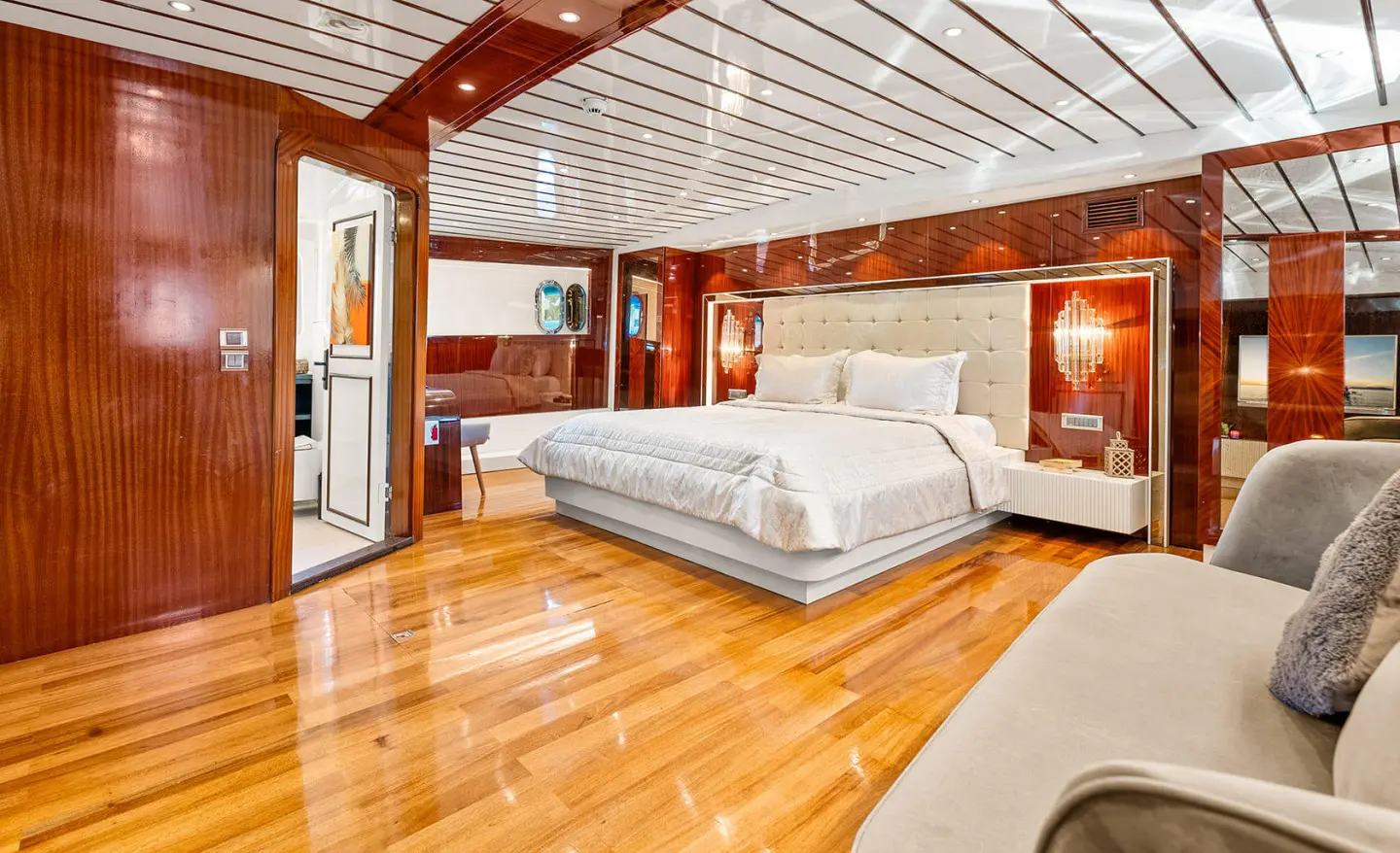 Esma Sultan yacht interior:sunlit wooden deck, large bed, marine windows