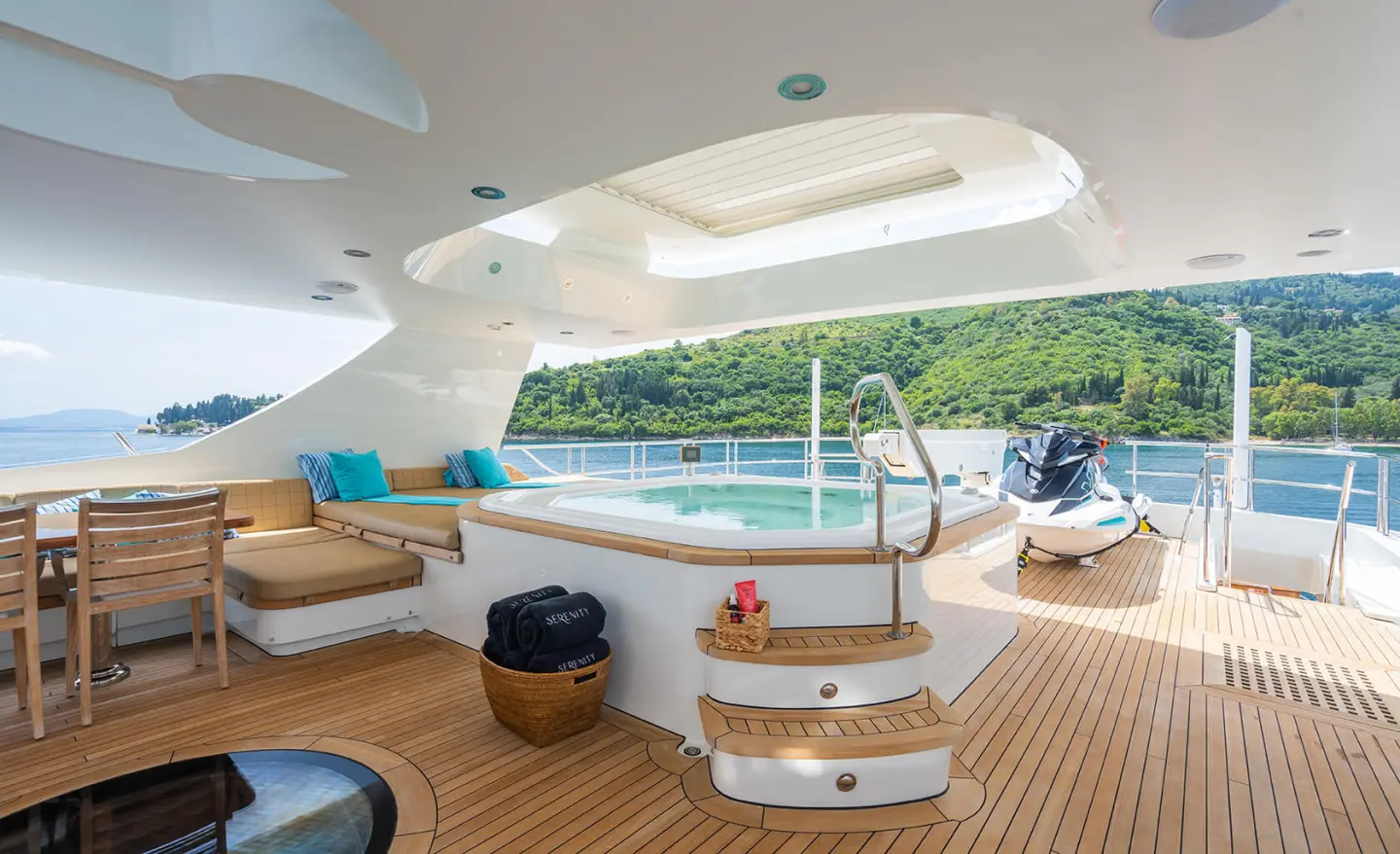 Modern yacht aft deck with jacuzzi, seating area and sun loungers