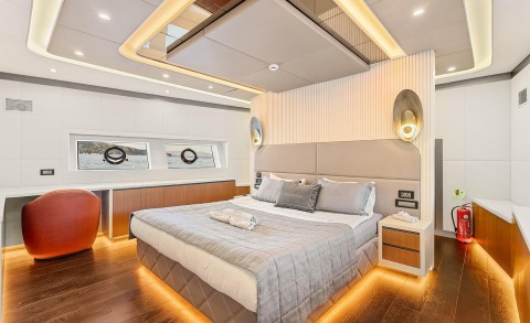 Modern hotel-style bedroom on a yacht with bedside tables and warm lighting