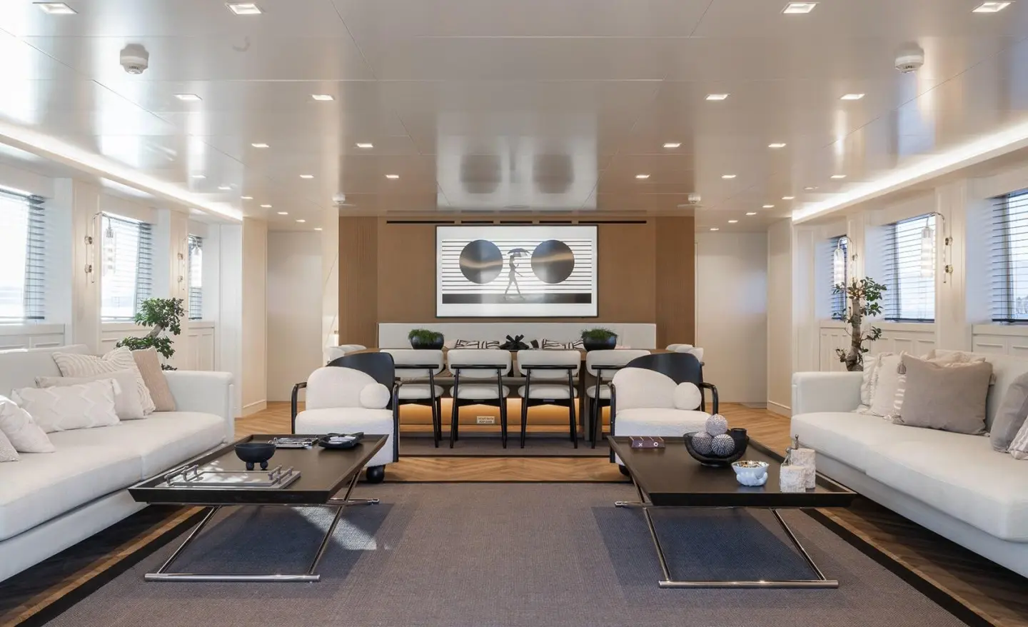 Luxurious yacht Illusion II salon with seating, lighting, and artwork