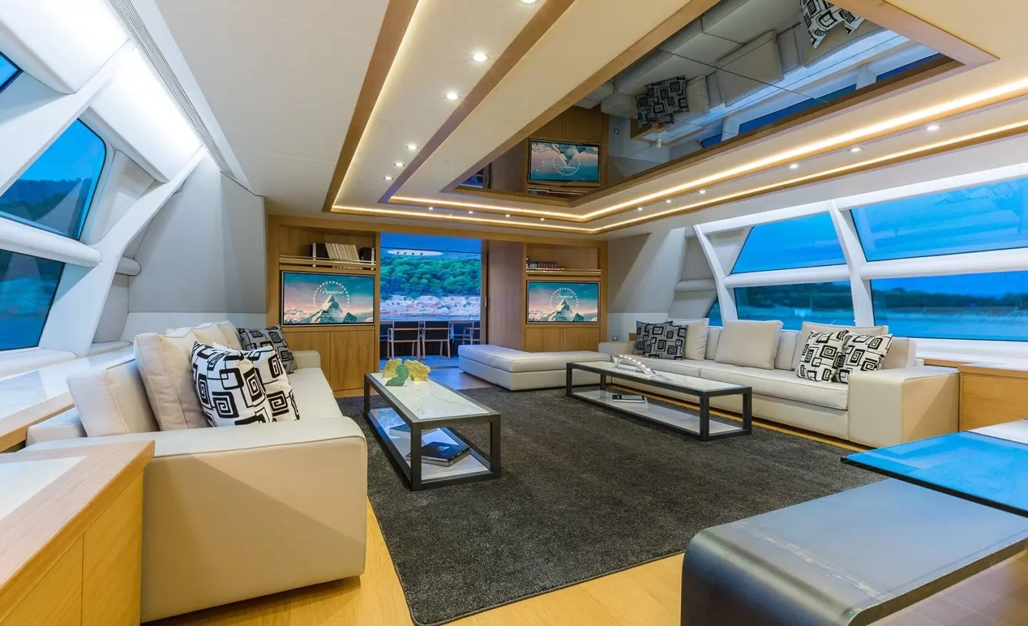 Aquarella yacht interior salon with seating, coffee table, and windows