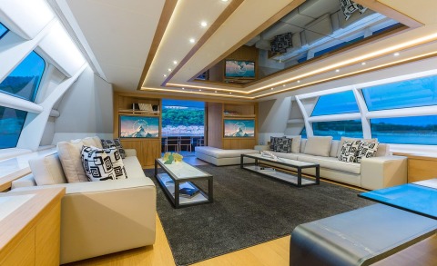 Aquarella interior living room with white sofas, modern coffee tables and built-in wood cabinets, TV screens