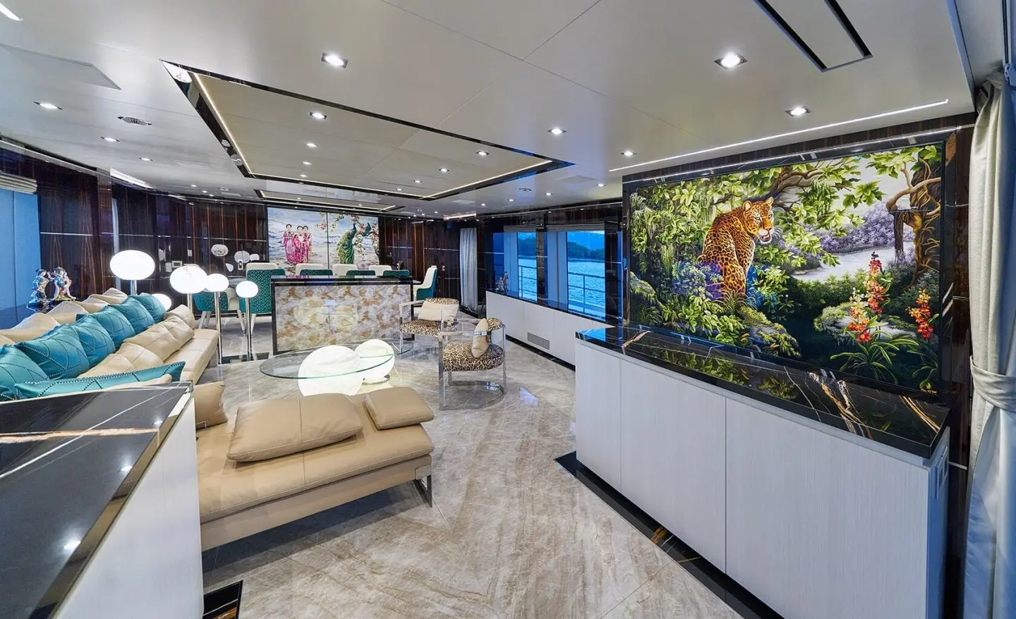 Interior of Happy Me motor yacht saloon with seating and aquarium feature