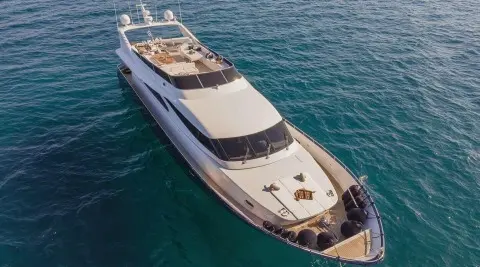 Top-down view of a luxury motor yacht named Zoi cruising blue ocean waters
