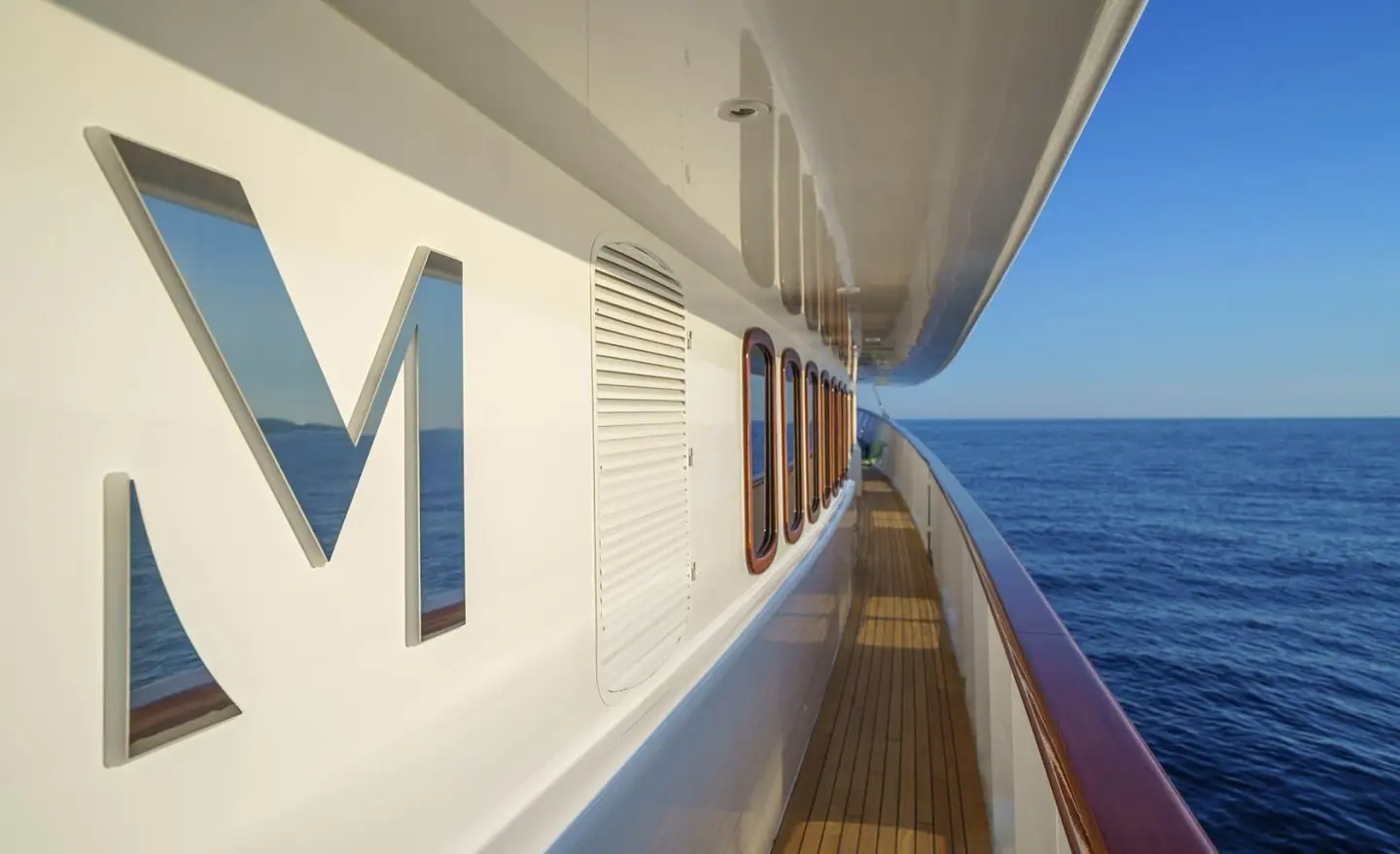 Maia yacht exterior deck side, ocean view, railing, blue water, side letters