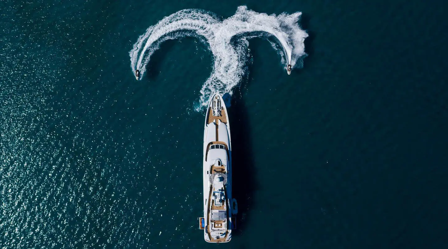 Alalya yacht on the water with a motor yacht and water sports gear visible