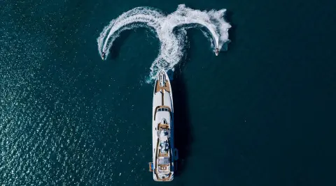 Alalya yacht on the water with a motor yacht and water sports gear visible