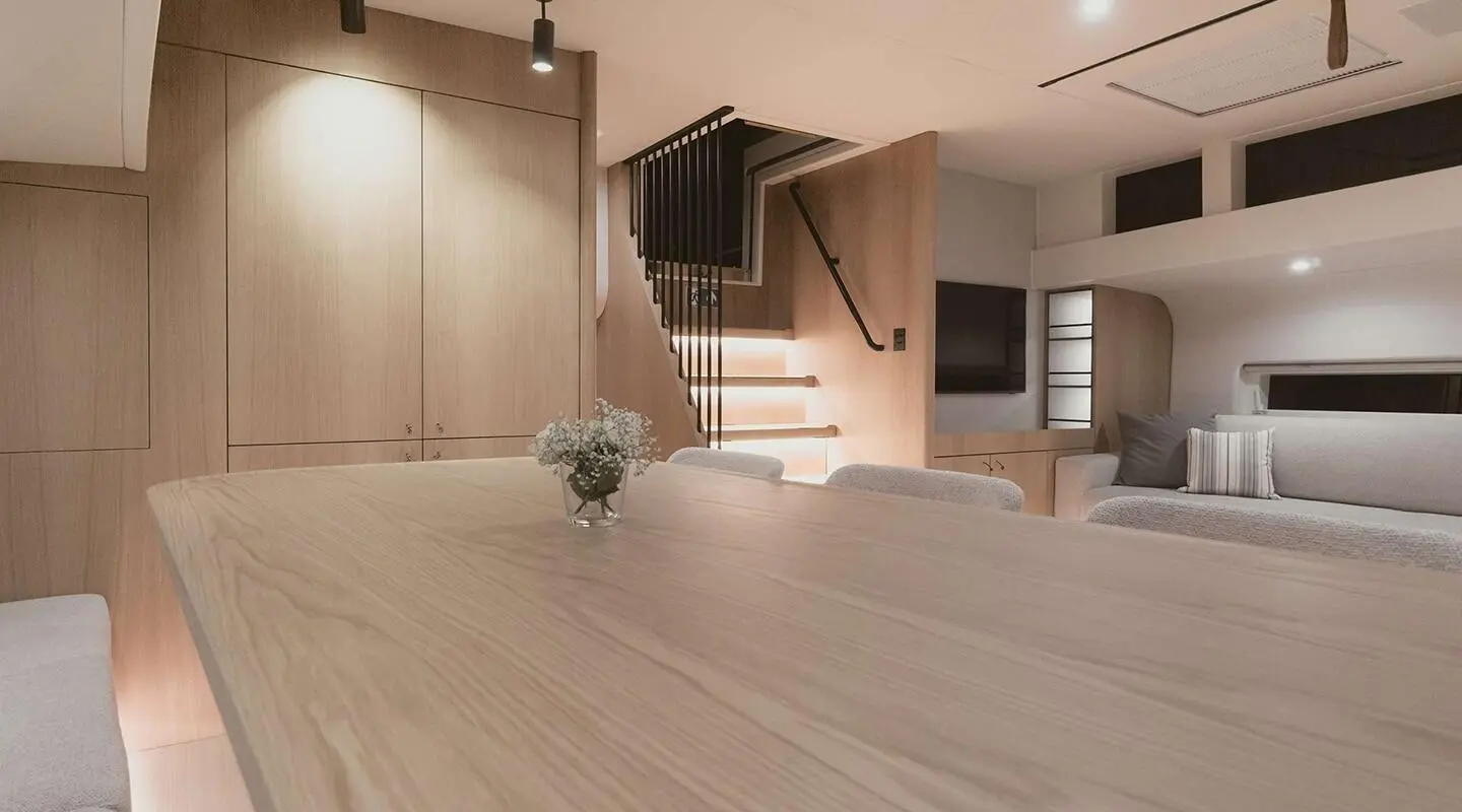 Nadamas yacht saloon interior with wood floors, stairs, and seating area