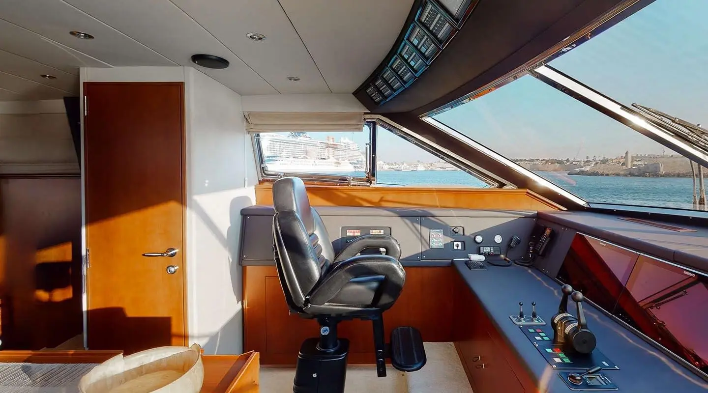 Bridge of Lady Natassa yacht at sunset with captain’s chair and instruments