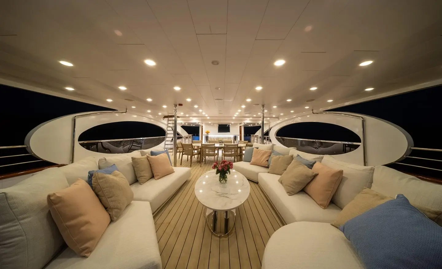 Luxurious yacht Olimp lounge area with cream seating and round tables