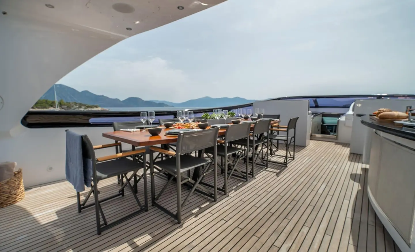 Pareaki II yacht on a sunlit flybridge with seating and dining area