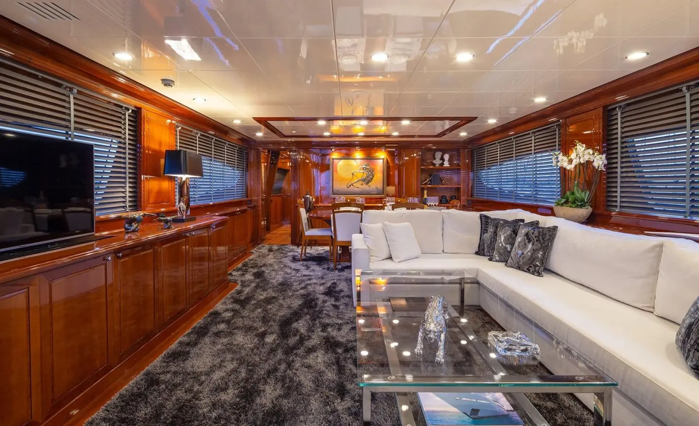 Luxury yacht Divine interior with wood panels, seating, and glass railing