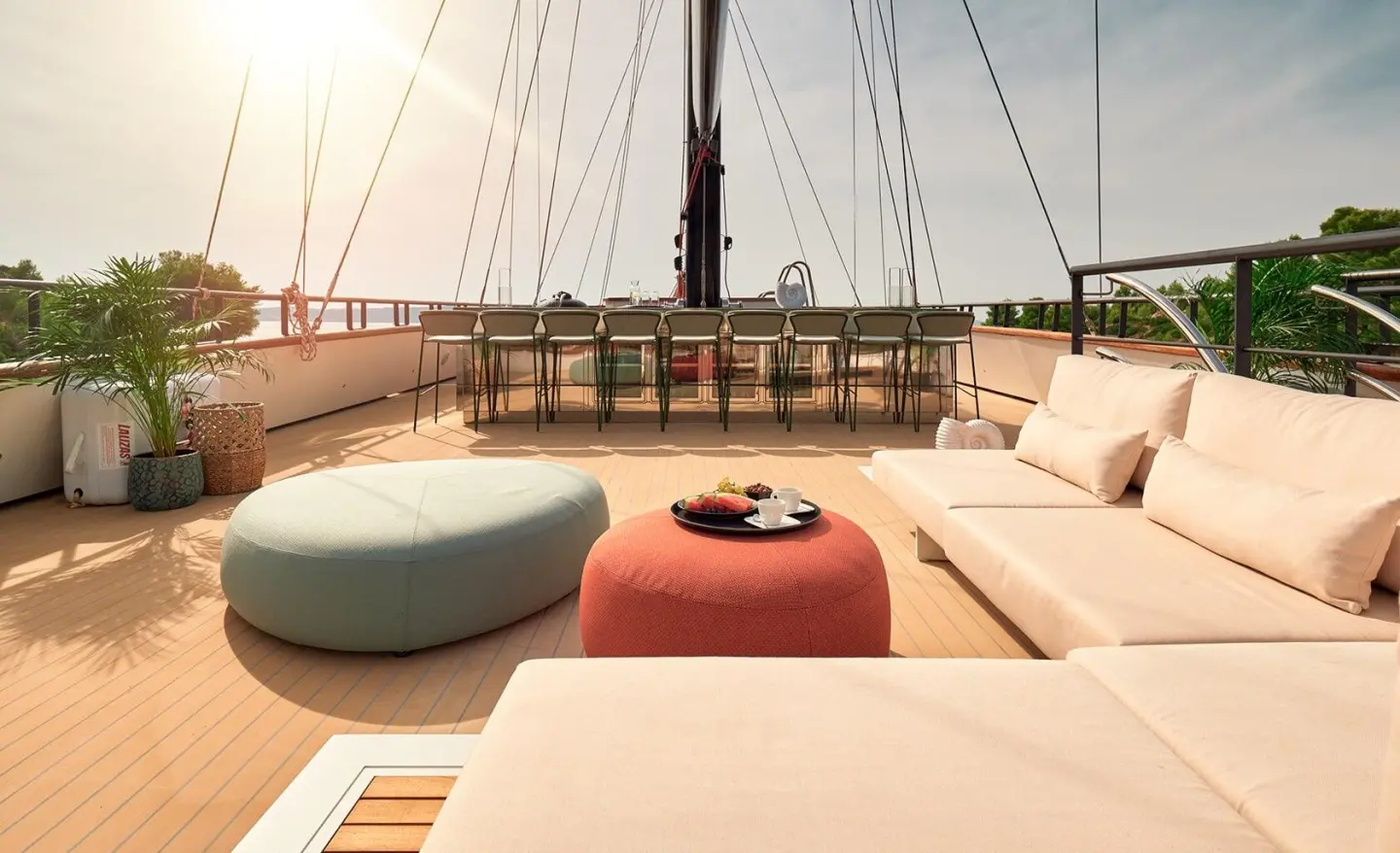 Yacht Anetta sun deck with loungers, cushions, and railing view at sea