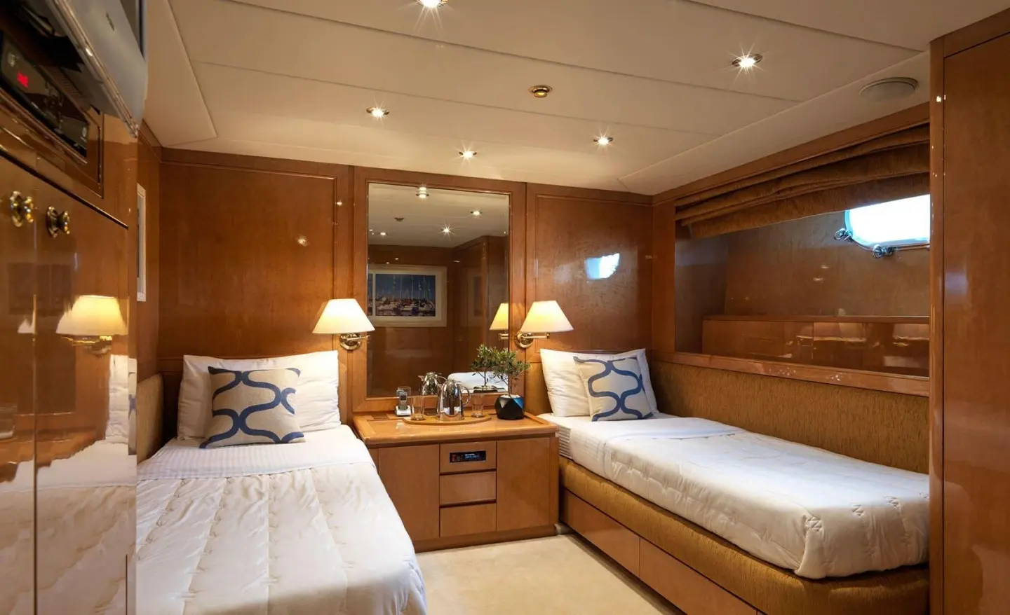 Idylle motor yacht interior with twin cabin, wood cabinetry, and beds