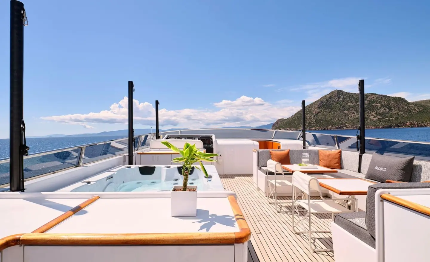 Mobius yacht deck with lounge chairs, sun umbrellas, and blue ocean view