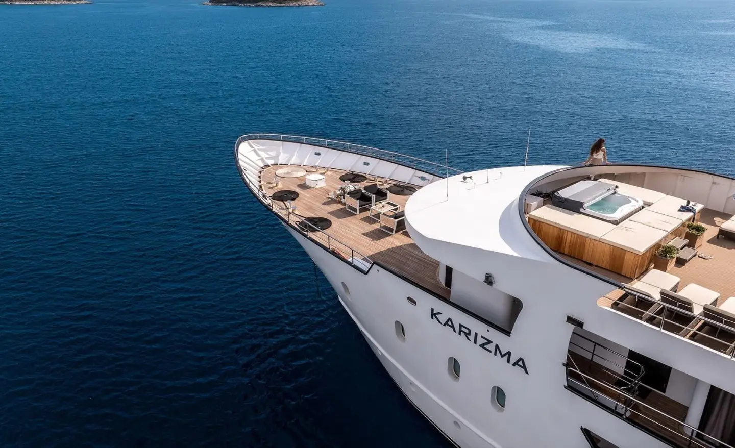 Aerial view of Karizma yacht bow deck with seating area, on blue sea