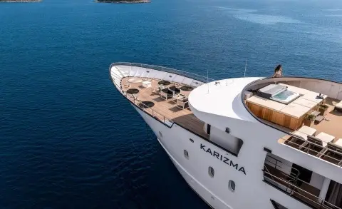 Aerial view of Karizma yacht bow deck with seating area, on blue sea