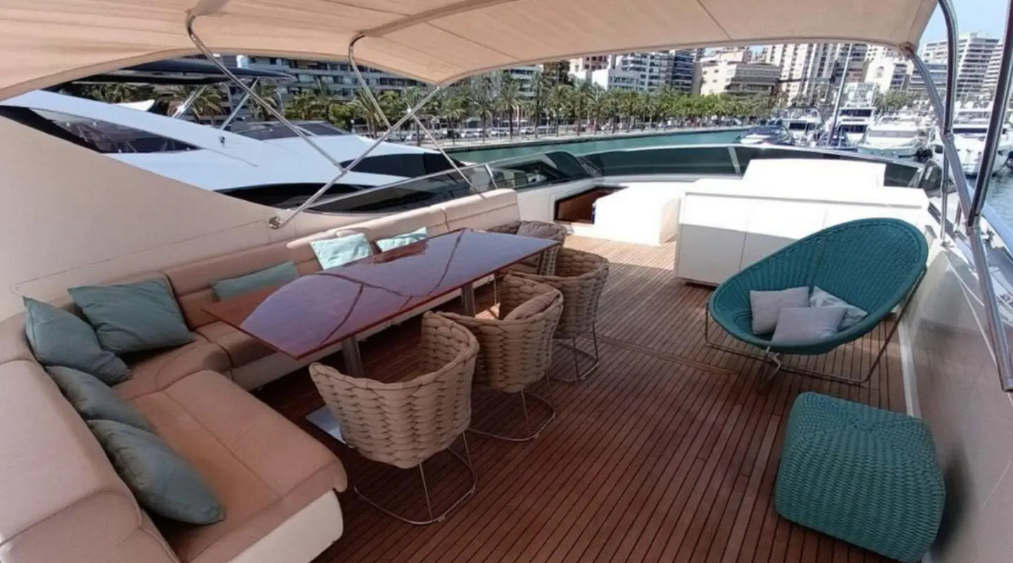 Aboard Miraval yacht: teak deck, seating area with cushioned sofas and table near helm