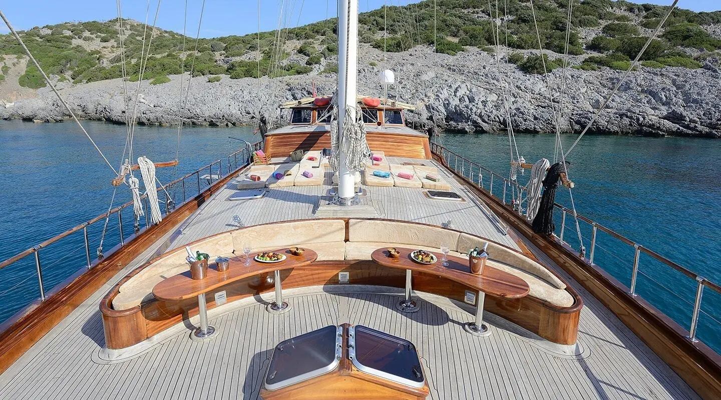 From bow view of Zephyria II yacht, wooden deck, ropes, and calm blue sea