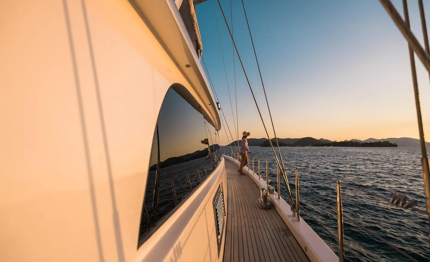 Side deck view of Angelo III gulet with teak railing and blue sea